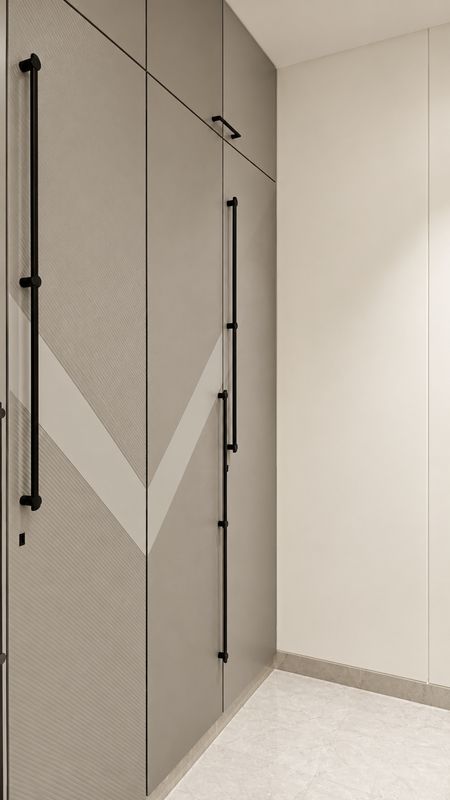 Tall grey wardrobe with a white chevron inlay and long black handles