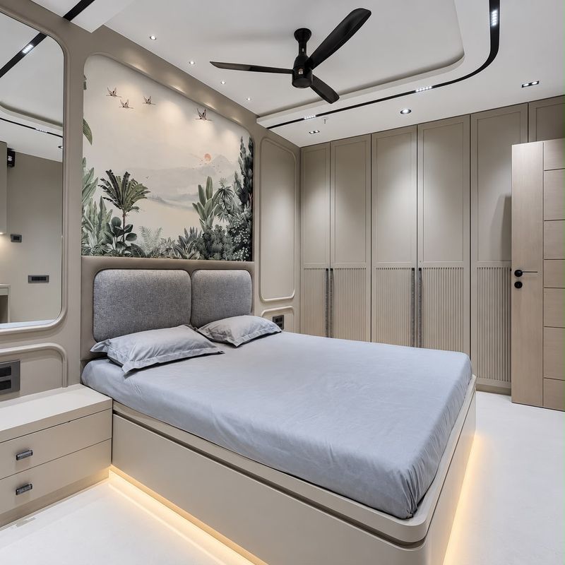 Bedroom with a grey padded headboard, a painted crane-and-forest mural, fluted wardrobes and a softly lit bed base