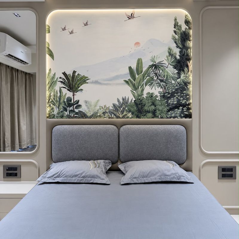 Grey padded headboard beneath a backlit crane-and-forest mural, with a mirror and curtain beside it