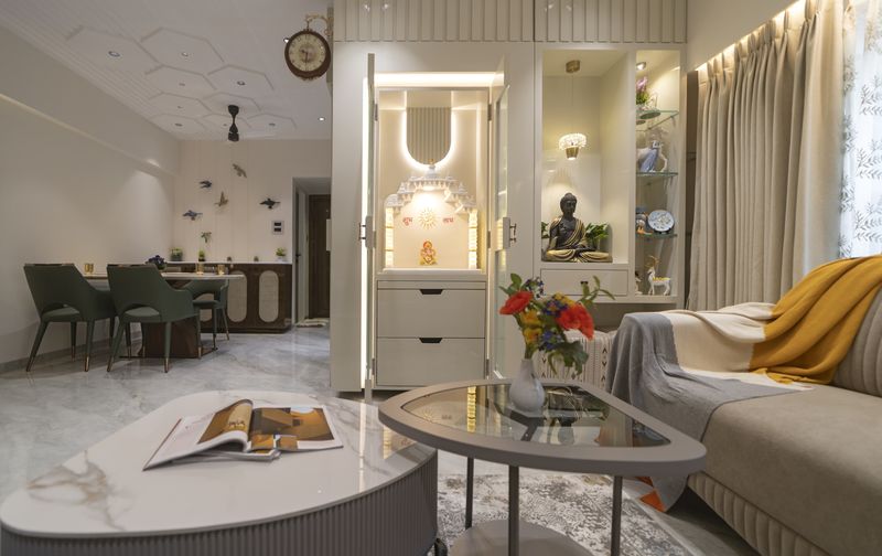 Living and dining area with a sculpted false ceiling and warm cove lighting