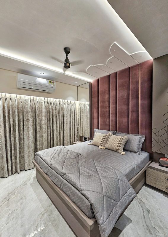 Master bedroom with a padded headboard and a curved false ceiling