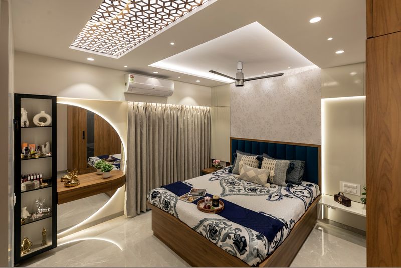 Bedroom with a fretwork ceiling panel, a round backlit mirror over a floating dresser, and a teal headboard